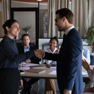 Smiling,Diverse,Multiracial,Employees,Handshake,Close,Deal,Agreement,At,Meeting.